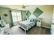 Cozy bedroom featuring ample natural light, unique wall decor, and neutral paint at 192 Waterpine Dr, Garner, NC 27529