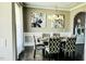 Dining room featuring chandelier, dark hardwood floors, and decorative artwork at 192 Waterpine Dr, Garner, NC 27529