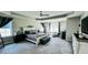 Spacious primary bedroom featuring tray ceilings, a ceiling fan, sitting area, and neutral colors at 192 Waterpine Dr, Garner, NC 27529