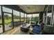 Relaxing screened patio with comfortable seating, ceiling fan, and a backyard view at 192 Waterpine Dr, Garner, NC 27529