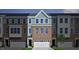 Attractive townhome with neutral brick, blue siding, a two-car garage, and classic architectural details at 2106 Pink Peony Cir # 146, Durham, NC 27703