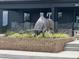 Stylish, modern home with striking metal bull sculpture on brick raised planter in front yard at 2106 Pink Peony Cir # 146, Durham, NC 27703