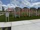 Community playground with modern, colorful equipment and a welcoming green space for children to enjoy outdoor activities at 2106 Pink Peony Cir # 146, Durham, NC 27703