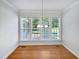 Bright dining room with decorative chandelier and multiple windows offering backyard view at 2408 Tiltonshire Ln, Apex, NC 27539