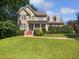 Charming two-story home with a welcoming front porch and manicured lawn at 2408 Tiltonshire Ln, Apex, NC 27539