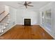 Bright living room featuring hardwood floors, a fireplace, and natural light at 2408 Tiltonshire Ln, Apex, NC 27539