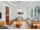 Staged living room features stylish furniture, a large window, and elegant decor at 2408 Tiltonshire Ln, Apex, NC 27539