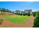 Expansive backyard with lush lawn and landscaped area with evergreens is perfect for outdoor activities at 241 Teague St, Wake Forest, NC 27587
