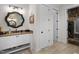 Bathroom featuring a decorative mirror, vanity with cabinets, and a doorway to a walk-in closet at 241 Teague St, Wake Forest, NC 27587