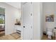 Bathroom showcasing a white vanity with a wood countertop, toilet, a patterned rug, and view into the bedroom at 241 Teague St, Wake Forest, NC 27587