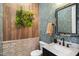 Unique powder room with stylish wallpaper, decorative mirror, a vessel sink, and wood paneled accent wall at 241 Teague St, Wake Forest, NC 27587