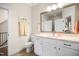 Bathroom with white cabinets, double sinks, a large mirror, and a toilet with decorative towels for an inviting space at 241 Teague St, Wake Forest, NC 27587