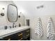 Bathroom featuring a marble countertop, dark wood vanity, and modern light fixtures at 241 Teague St, Wake Forest, NC 27587