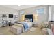 Bright bedroom with a bed, white desk, fan, and lots of natural light, providing a comfortable and stylish space at 241 Teague St, Wake Forest, NC 27587