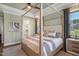 Bedroom with a four-poster bed, neutral tones, and view into a bathroom and the bedroom is illuminated with natural light at 241 Teague St, Wake Forest, NC 27587
