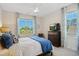 Sunlit bedroom showcasing stylish curtains, a comfortable bed, a ceiling fan, and a dresser with a TV at 241 Teague St, Wake Forest, NC 27587