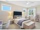 Bright bedroom with a bed, white desk, fan, and lots of natural light, providing a comfortable and stylish space at 241 Teague St, Wake Forest, NC 27587