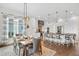 Bright, open-concept dining room, light wood table, and seamless flow into the kitchen at 241 Teague St, Wake Forest, NC 27587