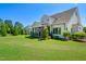 Beautifully designed home with screened-in porch and lush backyard featuring mature evergreens at 241 Teague St, Wake Forest, NC 27587