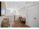 Upper level hallway featuring hardwood floors, decorative lighting, seating, and access to rooms with white doors at 241 Teague St, Wake Forest, NC 27587