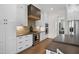 Modern kitchen features custom cabinetry, stainless steel appliances, tile backsplash, and hardwood floors at 241 Teague St, Wake Forest, NC 27587