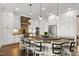 Spacious kitchen features a large island with seating, stainless steel appliances, custom cabinetry, and stylish pendant lighting at 241 Teague St, Wake Forest, NC 27587