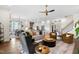 Bright, open-concept living room featuring hardwood floors, modern furniture, and seamless flow into the kitchen and dining areas at 241 Teague St, Wake Forest, NC 27587
