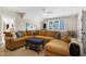Comfortable living room with a large sofa, window with blinds, and soft lighting, creating a welcoming and cozy atmosphere at 241 Teague St, Wake Forest, NC 27587