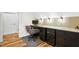 Home office with desk, chair, and custom cabinetry, featuring stylish lighting and wallpaper at 241 Teague St, Wake Forest, NC 27587