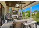 Screened-in patio with a fireplace, hanging chairs, and outdoor seating area at 241 Teague St, Wake Forest, NC 27587