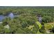 Aerial view shows a lakeside property, with dense trees and greenery, and an adjacent body of water at 276 Sagamore Dr, Louisburg, NC 27549