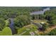 Beautiful aerial view of a waterfront community park with playground, parking, lake access, and lush green trees at 276 Sagamore Dr, Louisburg, NC 27549