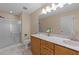 Bathroom featuring vanity with granite countertop, a shower, and ample natural light at 276 Sagamore Dr, Louisburg, NC 27549