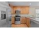 Updated kitchen with stainless steel appliances, granite countertops, and wooden cabinetry at 276 Sagamore Dr, Louisburg, NC 27549