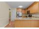 Kitchen with granite countertops, stainless-steel appliances, and access to a hallway and white door at 276 Sagamore Dr, Louisburg, NC 27549