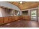 Bright living room features wood-paneled walls, wood ceiling, wood floor and multiple windows for natural light at 276 Sagamore Dr, Louisburg, NC 27549
