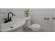 Compact bathroom featuring a modern sink, toilet, and white cabinets, perfect for smaller spaces at 2810 Bedford Green Dr # 5, Raleigh, NC 27604