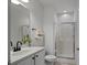 Bright bathroom featuring a vanity with white cabinets and black hardware, complemented by a glass shower at 2810 Bedford Green Dr # 5, Raleigh, NC 27604