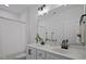 Bright bathroom featuring a dual sink vanity with white cabinets and black hardware, complemented by a shower with a white curtain at 2810 Bedford Green Dr # 5, Raleigh, NC 27604
