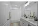 Bright bathroom featuring a dual sink vanity with white cabinets and black hardware, complemented by a shower with a white curtain at 2810 Bedford Green Dr # 5, Raleigh, NC 27604