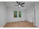 Bedroom featuring hardwood floors, a ceiling fan, and two windows that provide ample natural light at 2810 Bedford Green Dr # 5, Raleigh, NC 27604