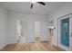 Open and bright bedroom showcasing an ensuite bathroom, walk-in closet, hardwood floors, and a door to the outside at 2810 Bedford Green Dr # 5, Raleigh, NC 27604