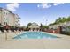 Inviting community pool with ample lounge seating, surrounded by well-maintained landscaping and brick fencing at 2810 Bedford Green Dr # 5, Raleigh, NC 27604