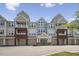 Attractive multi-story condo building featuring garages, balconies, and a welcoming entrance under a clear sky at 2810 Bedford Green Dr # 5, Raleigh, NC 27604