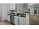 Kitchen featuring stainless steel appliances, granite countertops, white cabinetry, and a stainless steel sink at 2810 Bedford Green Dr # 5, Raleigh, NC 27604