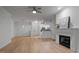 Living room features hardwood floors, a ceiling fan, a fireplace, and an open layout at 2810 Bedford Green Dr # 5, Raleigh, NC 27604