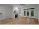 Bright living room with hardwood floors, fireplace, ceiling fan, and access to a patio at 2810 Bedford Green Dr # 5, Raleigh, NC 27604