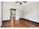Bedroom with hardwood floors leading to the kitchen, featuring an open doorway at 2927 S Church St, Rocky Mount, NC 27803