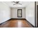 Bright bedroom featuring hardwood floors, large window, and ceiling fan at 2927 S Church St, Rocky Mount, NC 27803