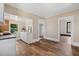 Open dining area with wood flooring and a view into the updated kitchen at 2927 S Church St, Rocky Mount, NC 27803